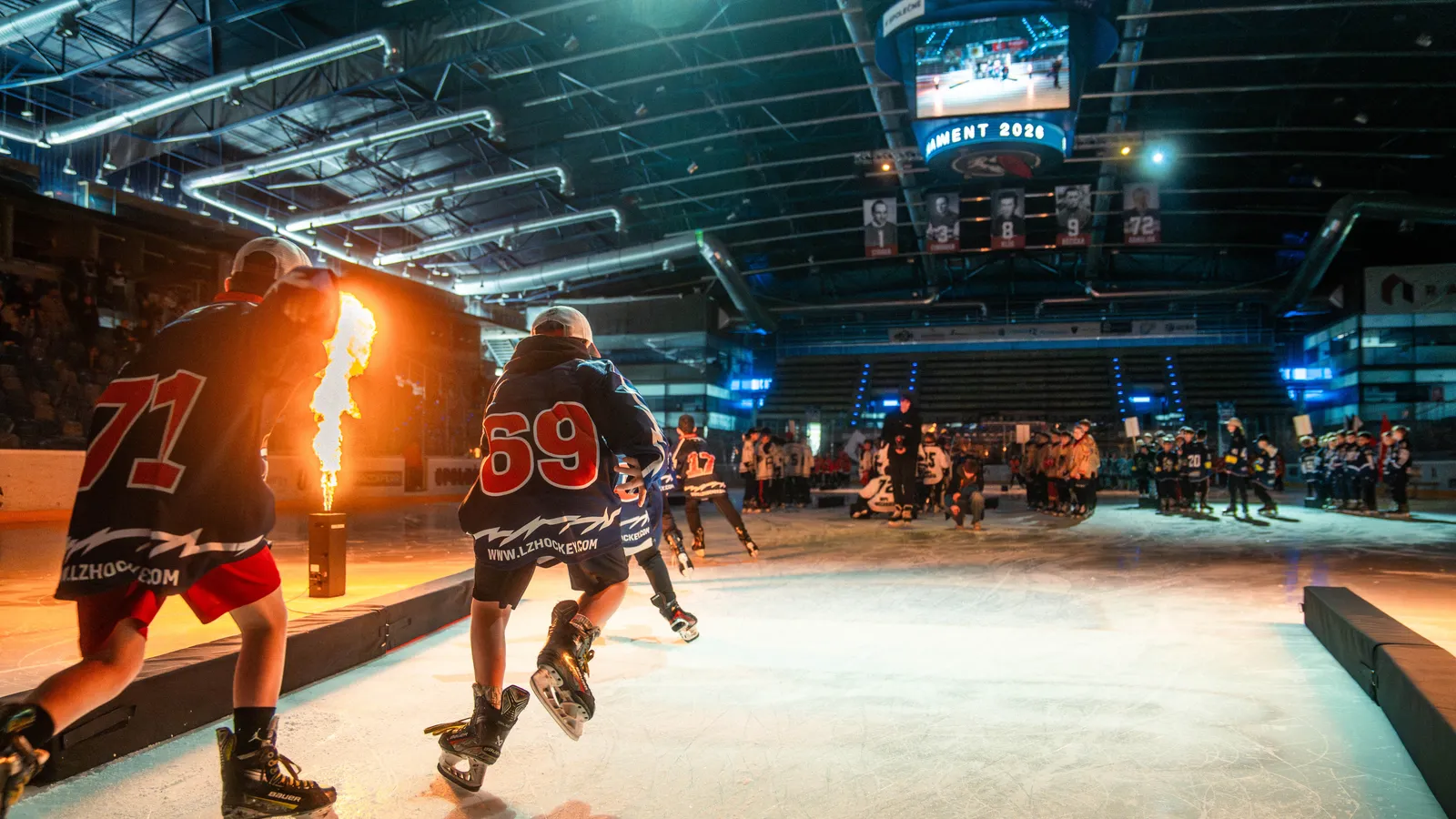 A player skates in between the flames